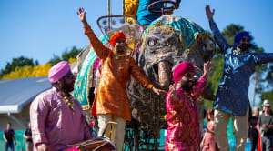 South East Asian men dancing in traditional clothing at festival